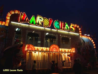Night scene of a Mardi Gras carnival ride. Bright lights.