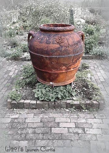 Black and white photo with colorized large, Victorian urn in a stone paved garden at Cross Keys Estate in New Jersey.